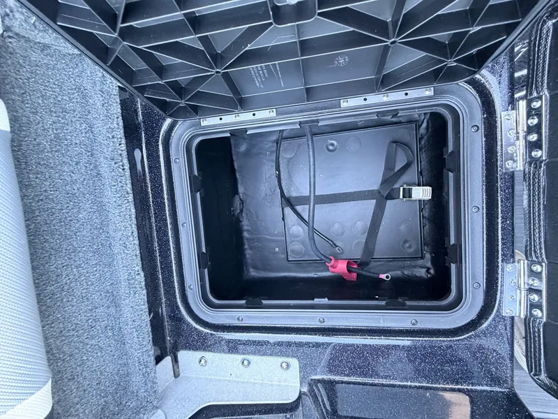 Slide: The Image of View into an open storage compartment with a black interior and straps. - 36