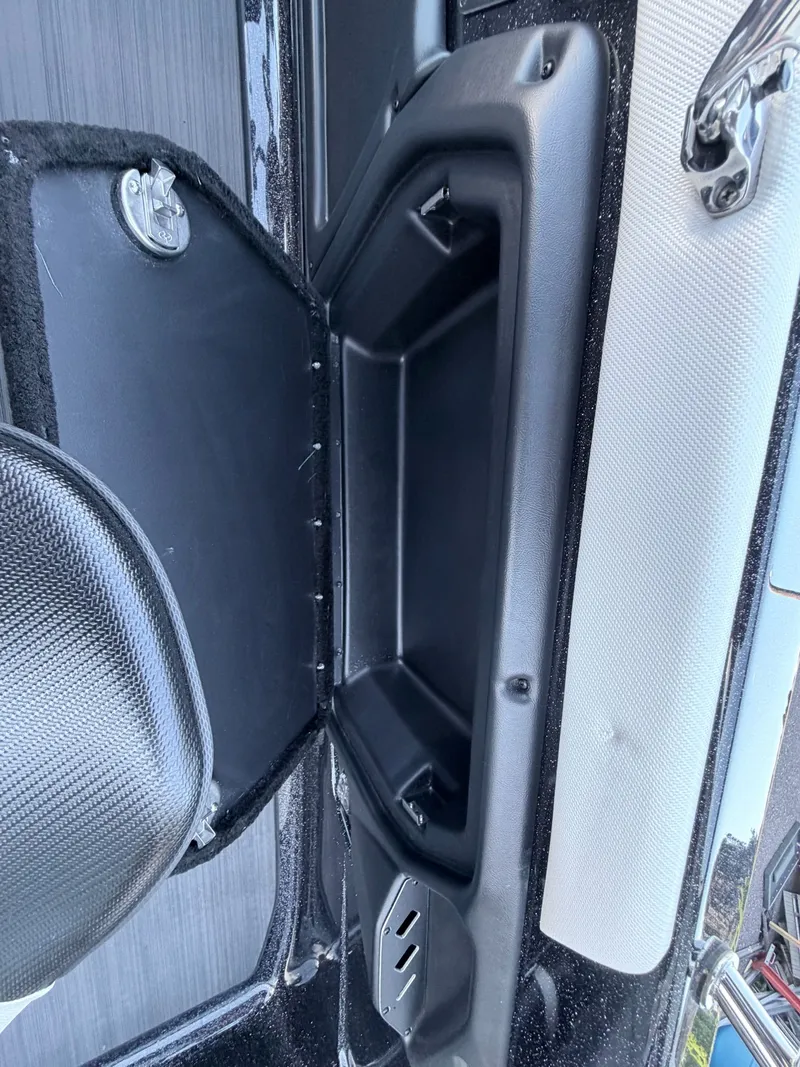 Slide: The Image of Close-up of a boat storage compartment with black plastic and gray fabric. - 41