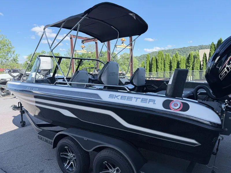 Slide: The Image of A 2025 Skeeter Solera 205 boat on a trailer. It features a black canopy. - 16