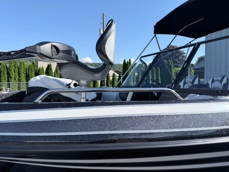 Slide: The Image of A modern boat with black and white design, featuring a comfortable seat and a Bimini top. - 35
