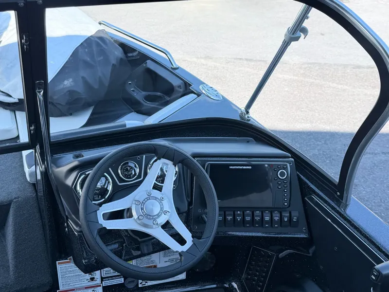 Slide: The Image of The image shows the cockpit of a Skeeter Solera 205 boat with modern steering and electronics. - 14