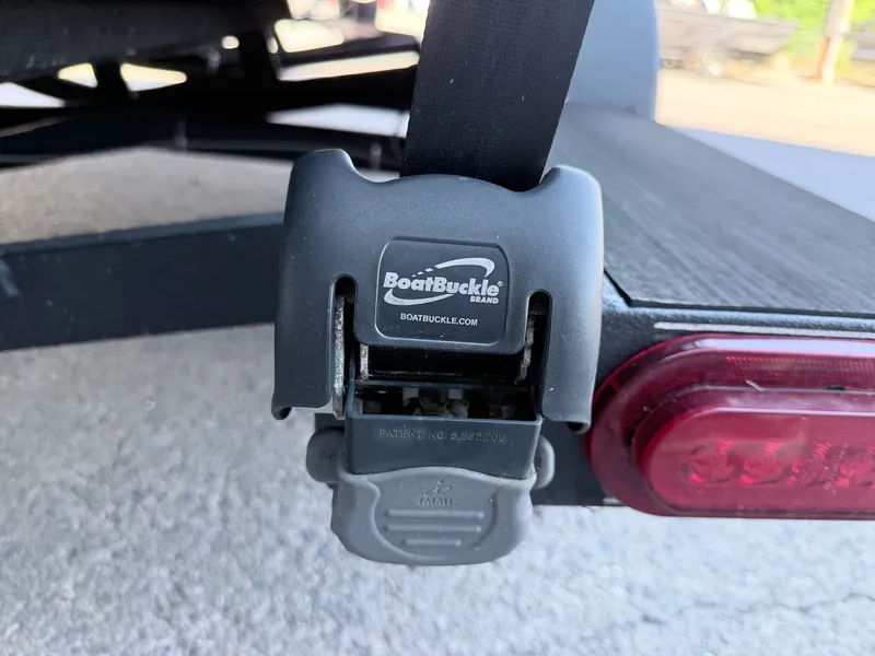 Slide: The Image of Close-up of a boat trailer strap labeled "BoatBuckle." - 12
