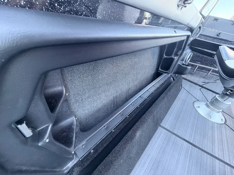 Slide: The Image of Close-up of a boat interior with gray carpeting and black details. - 23