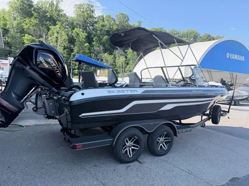 Slide: The Image of A 2025 Skeeter Solera 205 boat on a trailer. It features an outboard motor and a sunshade. - 31