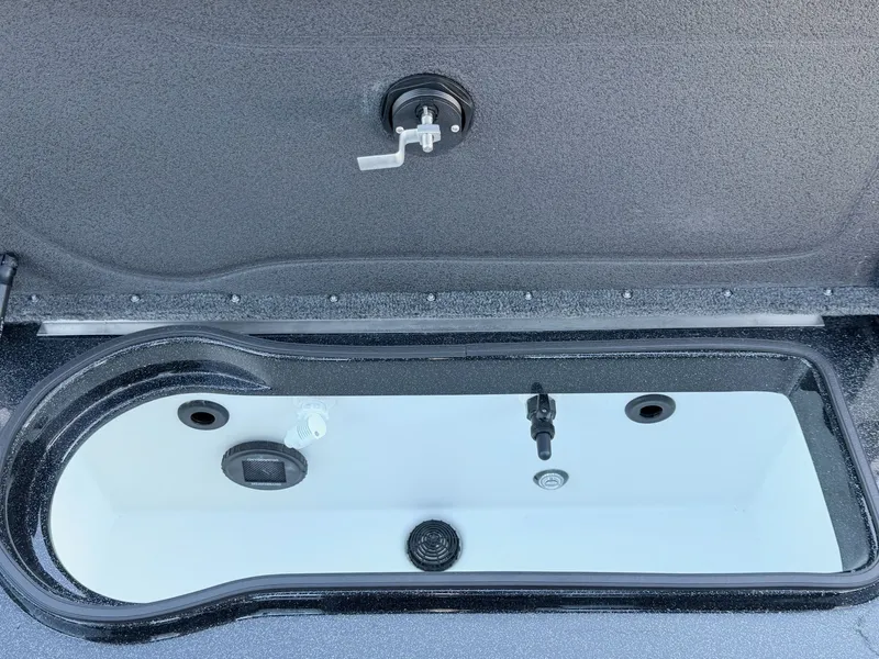 Slide: The Image of An open storage compartment with a drain and water connection in the boat. - 5