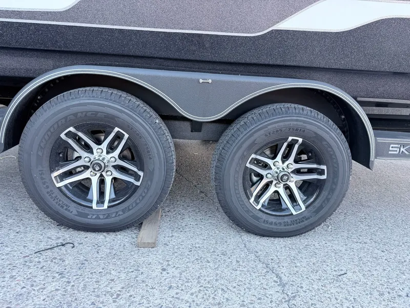 Slide: The Image of Close-up of dual axle tires on a Skeeter Solera 205 boat trailer. - 13