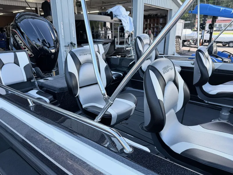 Slide: The Image of The image shows the interior of a Skeeter Solera 205 boat with modern seating and an engine. - 33