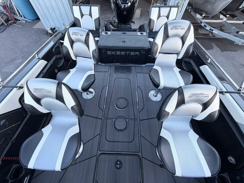 Slide: The Image of Interior view of a Skeeter Solera 205 boat with four cushioned seats and a motor in the background. - 38