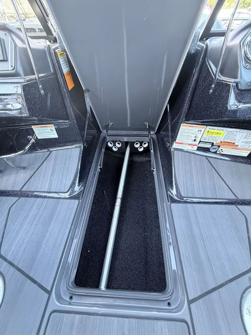 Slide: The Image of The image shows the storage compartment of a 2025 Skeeter Solera 205 boat. - 25