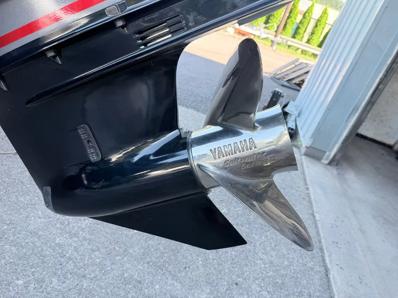 Slide: The Image of Close-up of a Yamaha outboard motor with stainless steel propeller, mounted on a boat. - 37
