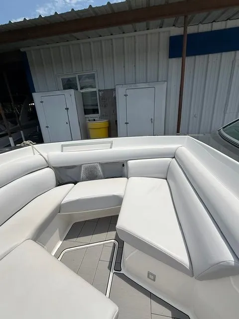 Slide: The Image of The image shows the seating area of a 2021 Aviara AV32 boat with white upholstery. - 24