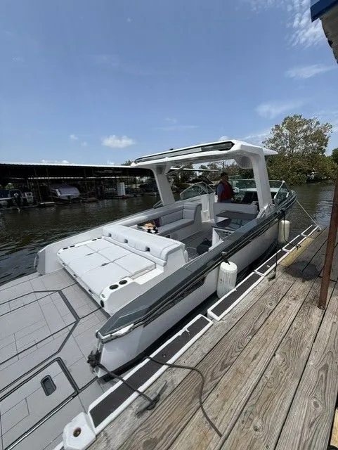 Slide: The Image of A 2021 Aviara AV32 boat docked at a wooden pier. It features a modern design. - 30