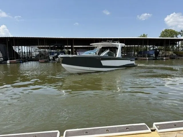 Slide: The Image of A 2021 Aviara AV32 boat is on the water near a dock. - 12