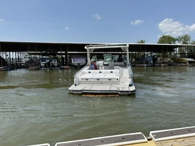 Slide: The Image of A 2021 Aviara AV32 on a lake. It's a sleek, modern boat. - 9
