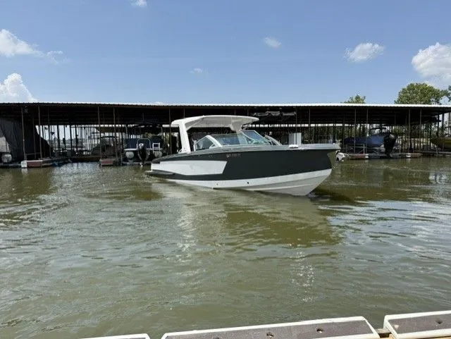 Slide: The Image of 2021 Aviara AV32 on calm water near a covered dock. - 4