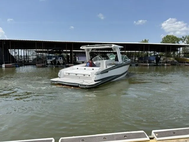 Slide: The Image of A 2021 Aviara AV32 cruising on calm waters in a marina area. - 7