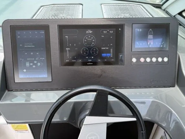 Slide: The Image of The image shows the dashboard of a 2021 Aviara AV32 boat with multiple screens. - 22