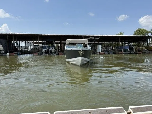 Slide: The Image of A 2021 Aviara AV32 boat is on the water in front of a covered dock. - 3