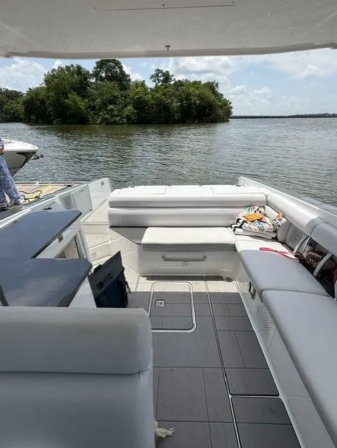 Slide: The Image of The interior of a 2021 Aviara AV32 with gray seating and a view of the water. - 21