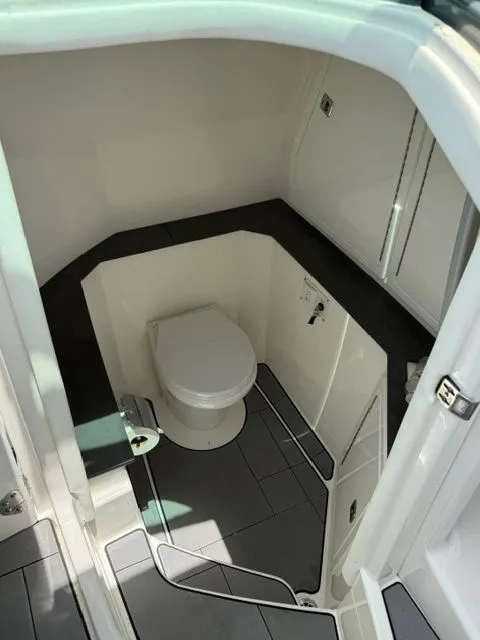 Slide: The Image of Interior of a 2021 Aviara AV32 featuring a toilet and modern fixtures. - 31