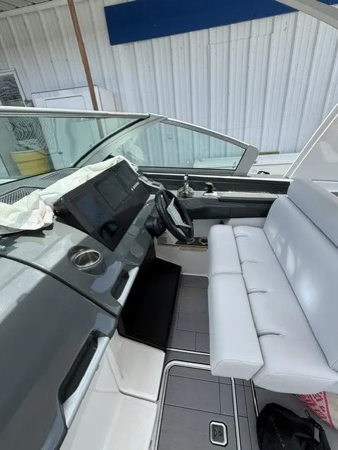 Slide: The Image of The image shows the cockpit of a 2021 Aviara AV32 with a modern helm and white seating. - 29