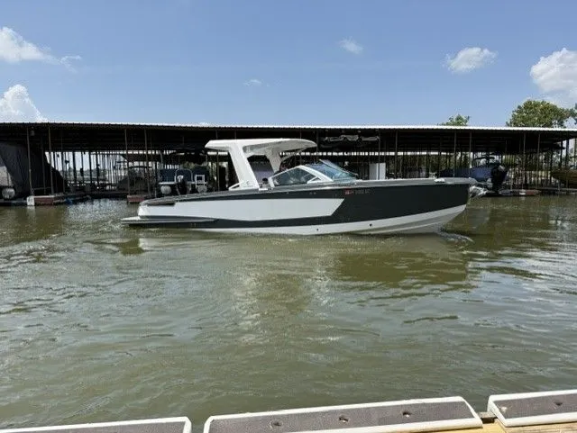 Slide: The Image of A 2021 Aviara AV32 boat floats on calm water in a marina. - 10