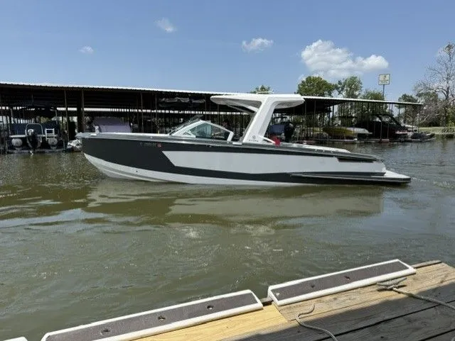 Slide: The Image of A 2021 Aviara AV32 boat is on the water next to a dock. - 6