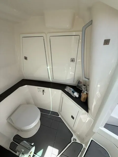 Slide: The Image of Interior view of a boat bathroom with toilet, sink, and storage space. - 20