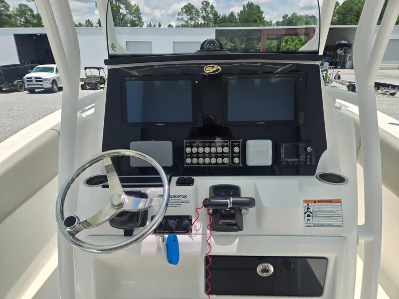 Slide: The Image of The image shows the helm of a Sea Fox 288 Commander boat with two screens and a steering wheel. - 5