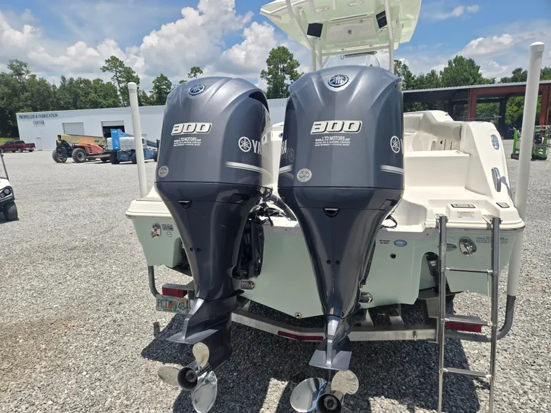 Slide: The Image of Two Yamaha outboard engines on a Sea Fox 288 Commander boat, parked on a gravel lot. - 4