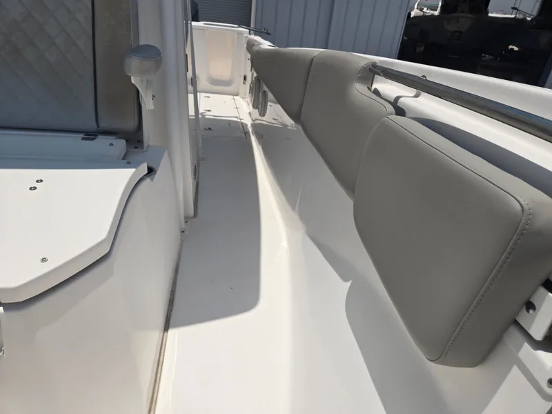 Slide: The Image of The image shows the interior of a Sea Fox 288 Commander boat with gray cushions. - 13