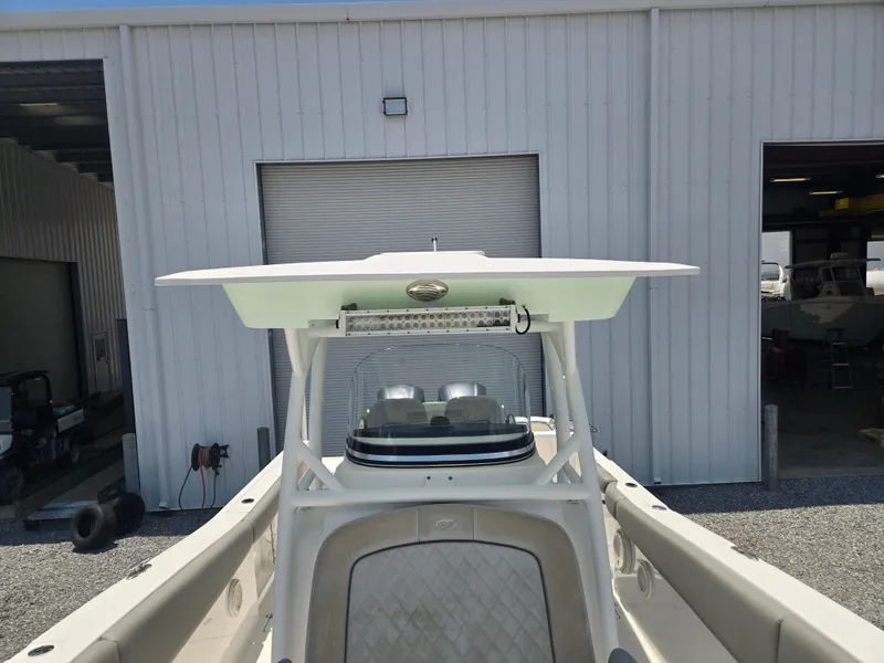 Slide: The Image of A 2019 Sea Fox 288 Commander with a T-top in front of a warehouse. - 12