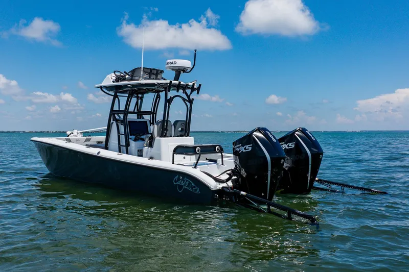 Slide: The Image of 2021 Costa Custom Boats 264HC on water, featuring dual outboard motors under a clear blue sky. - 13