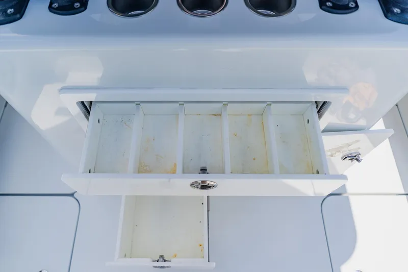 Slide: The Image of Open storage compartments on a 2021 Costa Custom Boats 264HC, showcasing interior organization. - 60