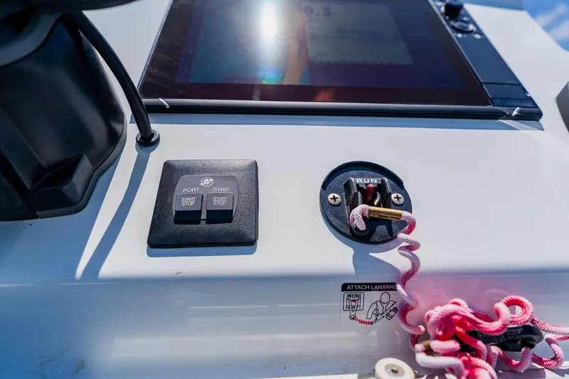 Slide: The Image of Control panel of 2021 Costa Custom Boats 264HC with start/stop buttons and safety lanyard. - 81