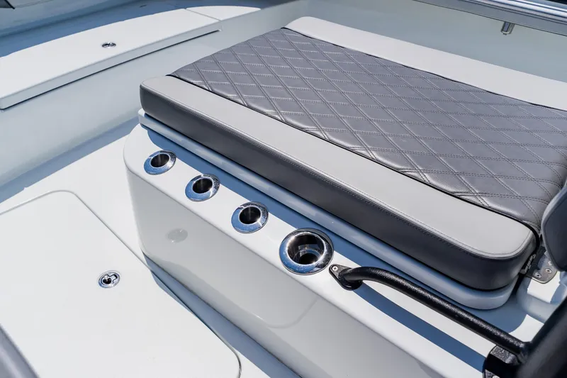 Slide: The Image of Luxury seating on 2021 Costa Custom Boats 264HC with cup holders and quilted upholstery. - 44