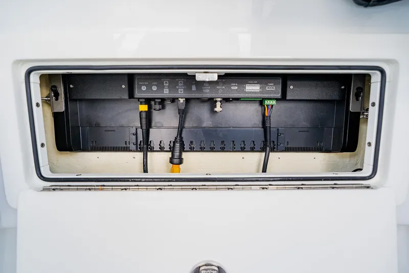 Slide: The Image of Electrical panel inside 2021 Costa Custom Boats 264HC, showcasing wiring and connections. - 51
