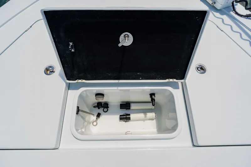 Slide: The Image of Open storage compartment on 2021 Costa Custom Boats 264HC, showcasing internal components. - 33