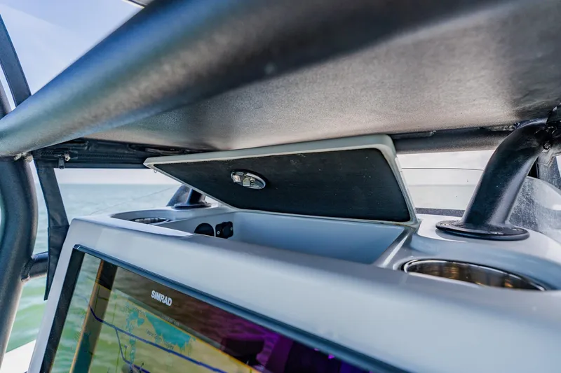 Slide: The Image of 2021 Costa Custom Boats 264HC dashboard with Simrad display and cup holders. - 74