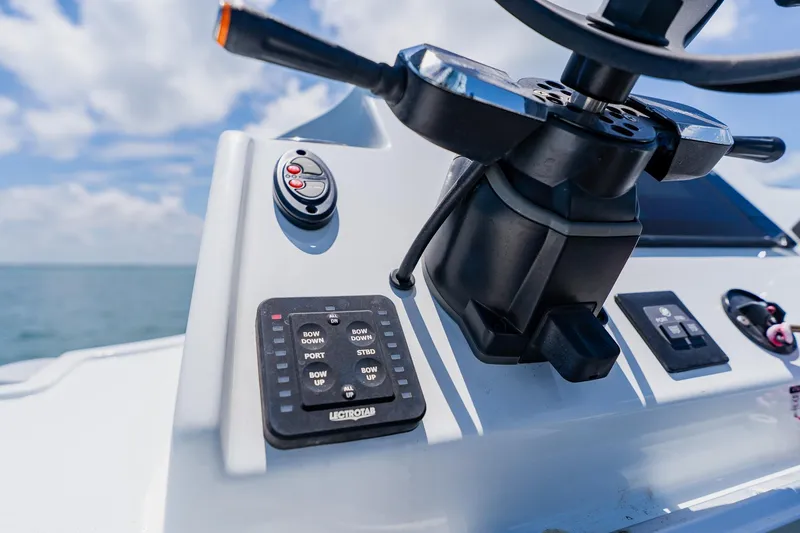 Slide: The Image of Close-up of 2021 Costa Custom Boats 264HC helm controls under a clear blue sky. - 80