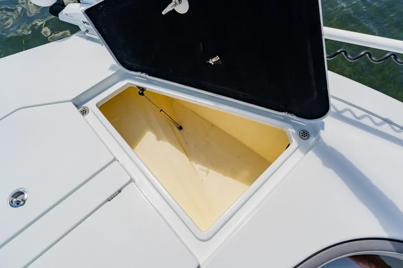 Slide: The Image of Open storage compartment on 2021 Costa Custom Boats 264HC, showcasing interior space. - 32