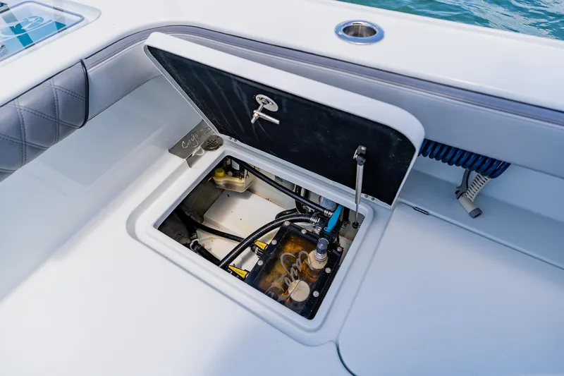 Slide: The Image of Open hatch on 2021 Costa Custom Boats 264HC, revealing internal components and wiring. - 95