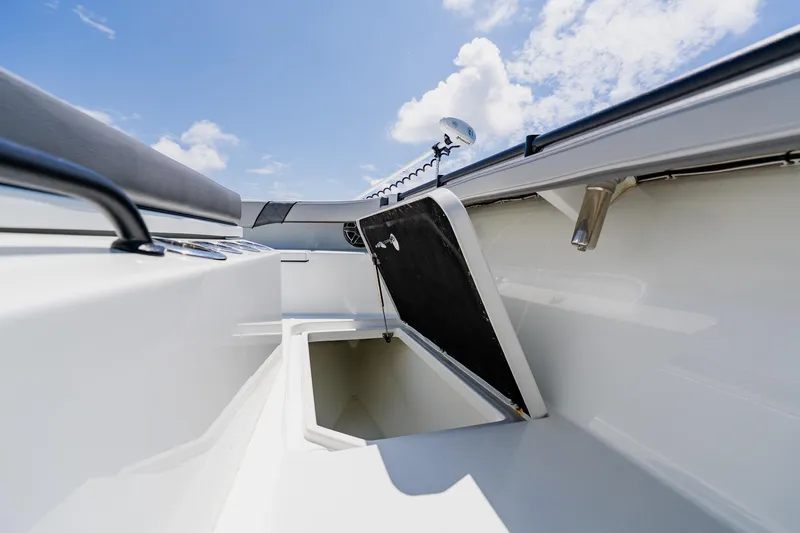 Slide: The Image of 2021 Costa Custom Boats 264HC interior storage compartment under blue sky. - 40