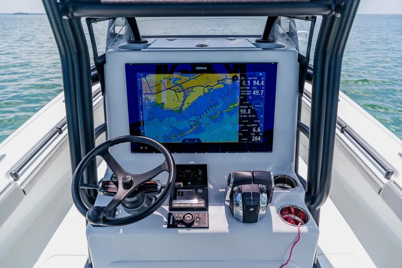Slide: The Image of Cockpit of 2021 Costa Custom Boats 264HC with navigation display and controls. - 63