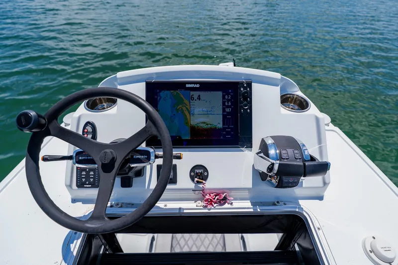 Slide: The Image of Helm of 2021 Costa Custom Boats 264HC with navigation display and controls on water. - 79