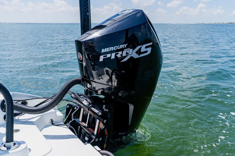Slide: The Image of Outboard motor on 2021 Costa Custom Boats 264HC in clear blue water. - 88