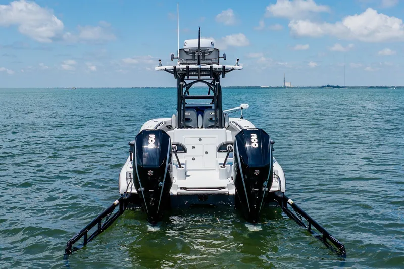 Slide: The Image of 2021 Costa Custom Boats 264HC on water, featuring dual outboard motors. - 15