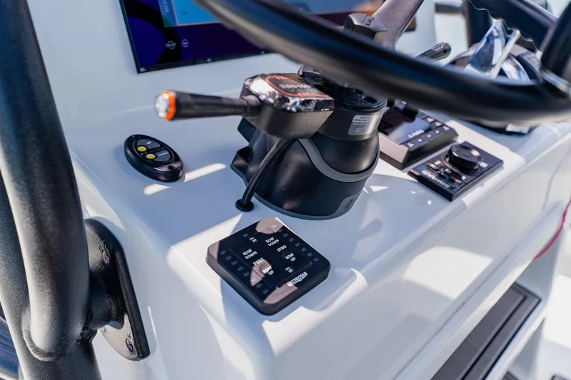 Slide: The Image of Control panel of 2021 Costa Custom Boats 264HC, featuring steering and navigation controls. - 72