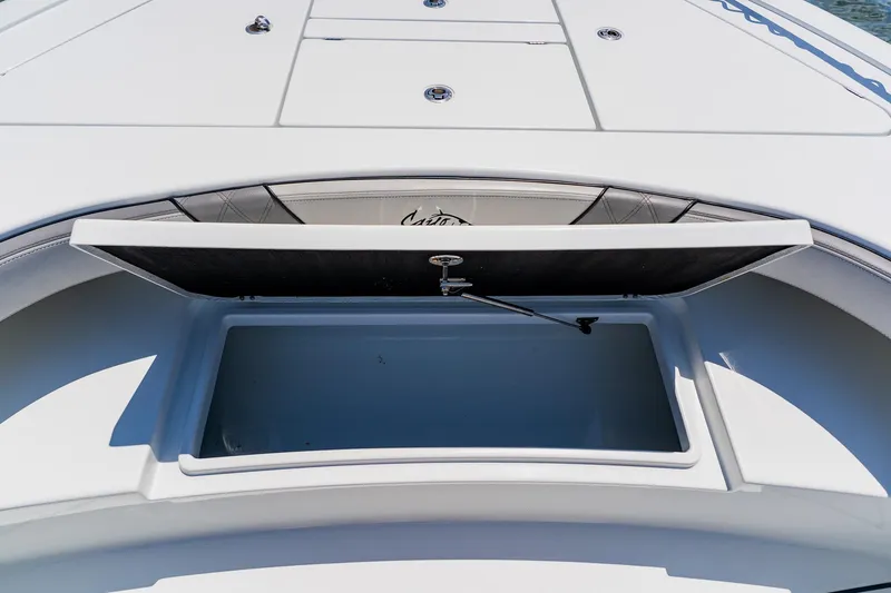 Slide: The Image of Open storage compartment on 2021 Costa Custom Boats 264HC deck. - 39