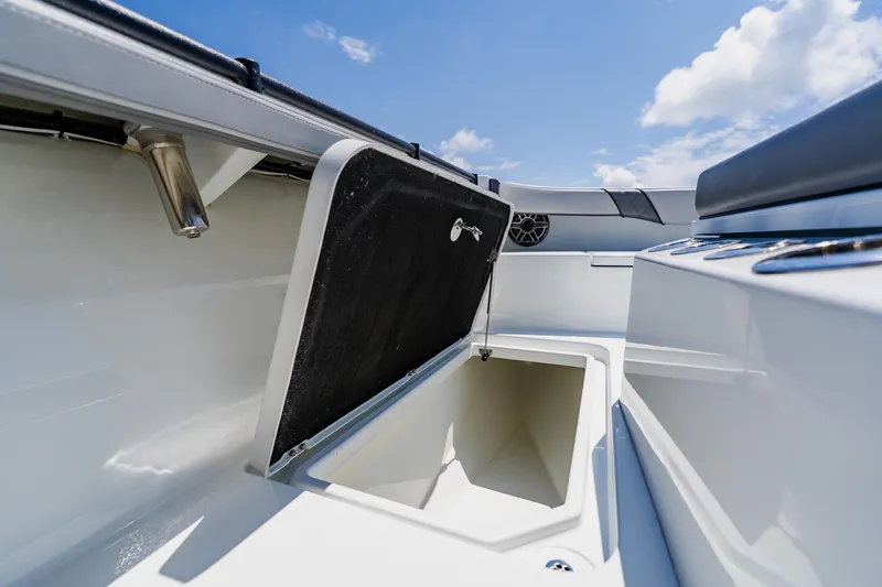 Slide: The Image of 2021 Costa Custom Boats 264HC storage compartment open under clear blue sky. - 43